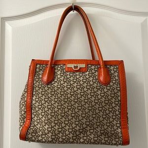 DKNY satchel bag with logo and orange leather trim interior like new